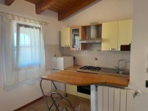 una cucina con piano di lavoro, lavandino e piano cottura di Appartamento a due passi dal mare. a Càbras