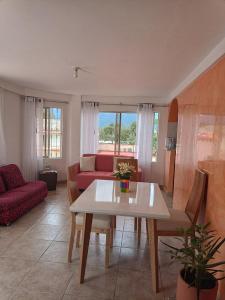 a living room with a table and a red couch at Apartamento Campestre en Condominio in Fusagasuga