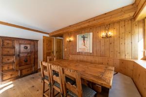 a dining room with wooden walls and a wooden table at Chesa Bellavista - St. Moritz in St. Moritz