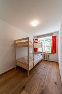 a bedroom with two bunk beds and a window at Chesa Bellavista - St. Moritz in St. Moritz