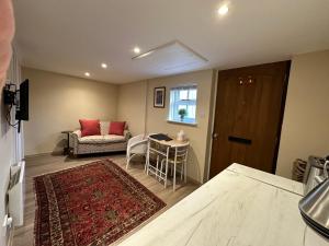 a living room with a couch and a table at Beautiful Cottage by The River Trent in Dunham