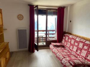 a living room with a couch in front of a window at T2, 5/6 pl, superbe vue, exp sud, douche italienne in LʼHuez