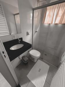 a bathroom with a sink and a toilet and a shower at Hotel Rosa Viva in Barretos