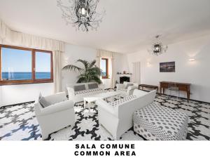 ein Wohnzimmer mit weißen Möbeln und einem Kronleuchter in der Unterkunft Affittacamere Lo Scoglio (Guesthouse) in Monterosso al Mare