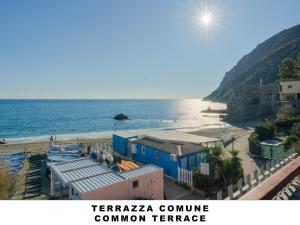 a view of a beach with houses and the ocean at Affittacamere Lo Scoglio (Guesthouse) in Monterosso al Mare