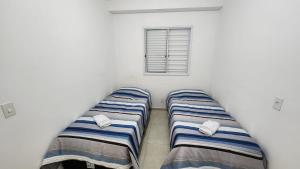 A bed or beds in a room at Apartamento em itanhaem