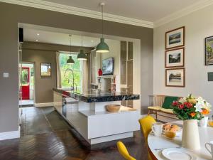 a kitchen and living room with a counter and a table at Little Parrock, Grasmere in Grasmere