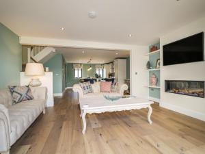 a living room with a couch and a coffee table at Tarn End Cottages 12 in Brampton