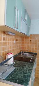 a kitchen with a sink and a counter top at Sea and Sunshine in Tivat