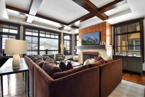 a living room with a large couch and a fireplace at Flagstaff #301 in Park City