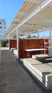 a pavilion with a picnic table under a white canopy at Marina La Serena, Playa Cuatro Esquinas in La Serena