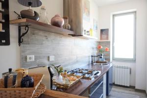 a kitchen with a counter with a stove top oven at Jerry & Titty house in Capena