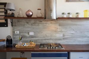 a kitchen with a stove and a counter top at Jerry & Titty house in Capena