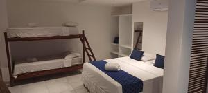 a small room with two bunk beds in it at Pousada Mediterrânea in Pipa