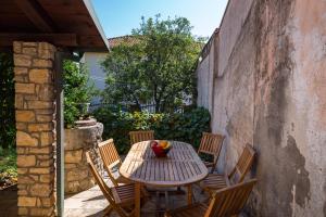 a wooden table and chairs on a patio at CROATIAN STONE GEM in Posedarje