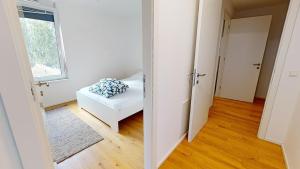 a living room with a white couch and a window at PA14 Modern apartment with a private garage near Schönbrunn Palace T5 in Vienna