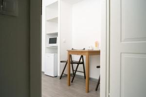a room with a desk and a table and a table and a door at Flats Kruzhka-podushka on Krisanova Street in Perm