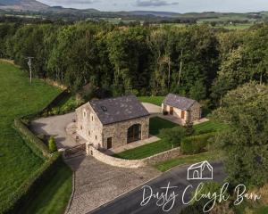 an aerial view of a stone house with a driveway at Dusty Clough Barn in Preston