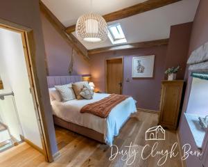 a bedroom with a bed and a pendant light at Dusty Clough Barn in Preston