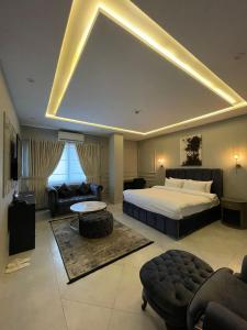 a large bedroom with a bed and a couch at Villa Vista in Islamabad