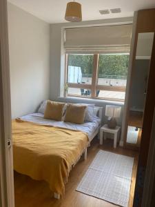 a small bedroom with a bed with a window at Modern 2 Bed Apartment Next To Station + Parking in Beckenham