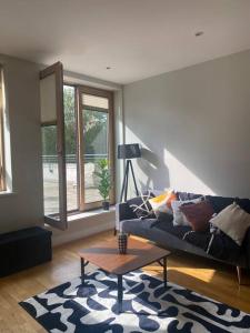 a living room with a couch and a coffee table at Modern 2 Bed Apartment Next To Station + Parking in Beckenham