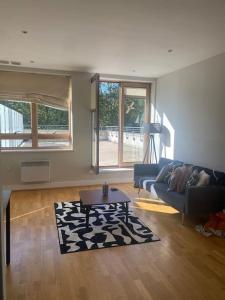 a living room with a couch and a table at Modern 2 Bed Apartment Next To Station + Parking in Beckenham
