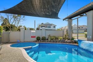 a swimming pool in the backyard of a house at Taupo Central Apartment in Taupo