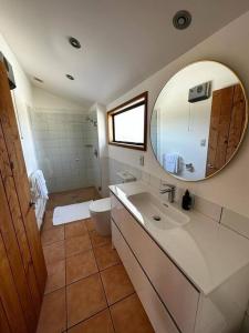 a bathroom with a sink and a toilet and a mirror at Woolshed 17 - Self Catering Accommodation in Havelock North
