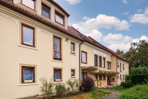 a large white building with a lot of windows at Apartmány Kateřina in Ricany