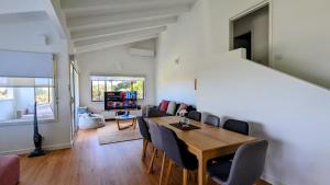 a dining room and living room with a table and chairs at Venus Bay Blue in Venus Bay