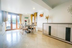 a living room with a table and a dining room at #FW The House of Sunny Gardens in Saint-Ismier