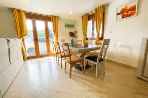 a kitchen and dining room with a table and chairs at #FW The House of Sunny Gardens in Saint-Ismier