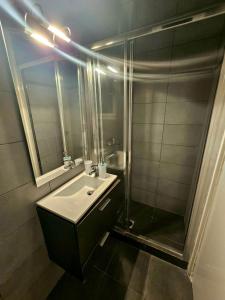 a bathroom with a sink and a shower at Corfu Glyfada Beach Apartment 59 in Glyfada