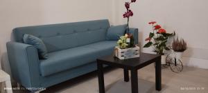 ein blaues Sofa im Wohnzimmer mit einem Tisch in der Unterkunft PisoYari in Santa Cruz de la Palma