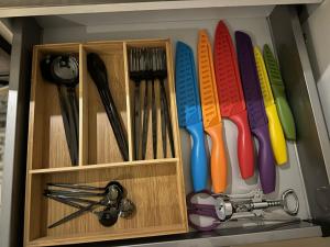 a cabinet with colorful utensils in it at Luxury Townhouse, Manchester Sleeps 6 in Manchester