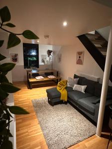 a living room with a couch and a staircase at Luxury Townhouse, Manchester Sleeps 6 in Manchester