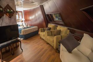 a living room with a couch and a bed at Upper Sky Tours 5 Stars Nile Cruises Sailing From Luxor To Aswan Every Saturday & Monday For 4 Nights - From Aswan Every Wednesday and Friday For Only 3 Nights With All Visits in Luxor