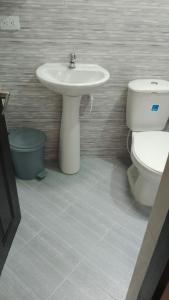 a bathroom with a sink and a toilet at Casa Shalom R.G. in Paipa +5 photos