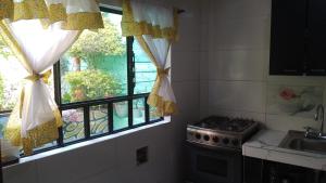 a kitchen with a stove and a window at Casa Shalom R.G. in Paipa