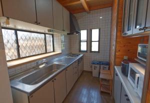 a kitchen with a sink and a stove at ocean resort mint - Vacation STAY 62442v in Minamiboso