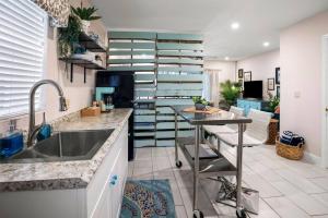 a kitchen with a sink and a counter top at Waterfront Studio Just minutes to Naples Beaches in Naples