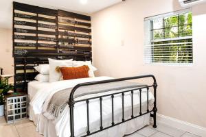 a bedroom with a bed with a black headboard at Waterfront Studio Just minutes to Naples Beaches in Naples