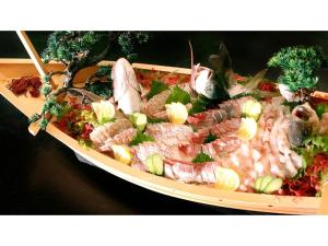 a plate of food with seafood on a table at Yunohama Onsen Hanayubi Nihonkai - Vacation STAY 67567v in Tsuruoka
