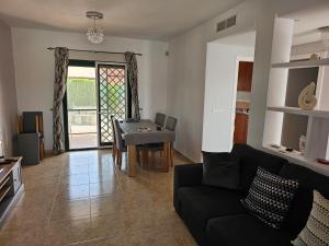 a living room with a black couch and a table at Stunning 3-Bed Villa detached with private pool in Zurgena