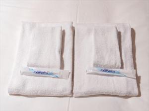 two towels sitting on top of a bathroom counter at Chachamaru Osaka Castle Park - Vacation STAY 15422 in Osaka