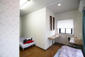 a room with a bed and a table and a window at cold - Vacation STAY 69755v in Kumamoto