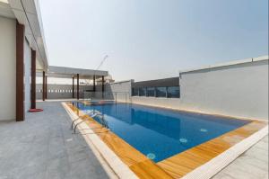 a swimming pool on the roof of a building at Bright & Cozy, Near Metro & Downtown, Pool, Gym in Dubai