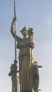 a statue of a man holding a flag on a building at Saint Mandé Paris in Saint-Mandé