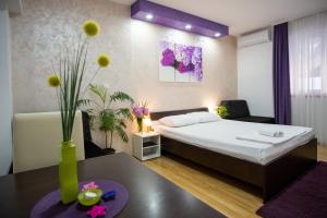 a hotel room with a bed and a table at Apartments Sweet Dreams in Trebinje